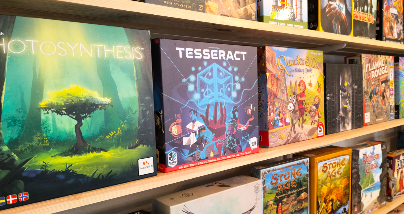  vast collection of board games fills shelves that seem to stretch into the distance. The titles 'Photosynthesis,' 'Tesseract,' 'Quacks of Quedlinburg,' 'Flamme Rouge,' and 'Stone Age' are visible. A navigation widget labeled 'Discover Treasures' invites you to explore further.